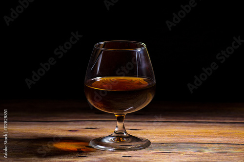 Cognac glass at the wooden table