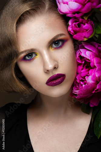 Beautiful girl with colorful make-up, flowers, retro hairstyle. beauty face.