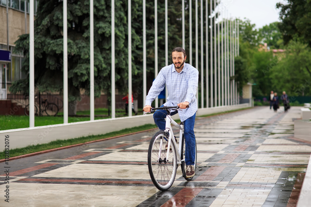 young hipster man with fixed gear bike on city street young hipster man with fixed gear bike on city street