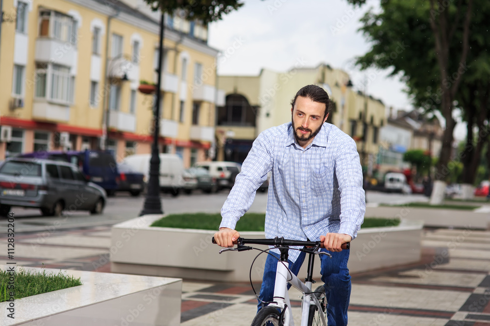 young hipster man with fixed gear bike on city street young hipster man with fixed gear bike on city street