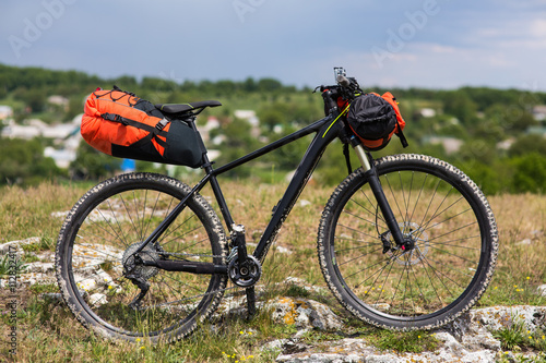 Bicycle with orange bags for travel © Aleksey