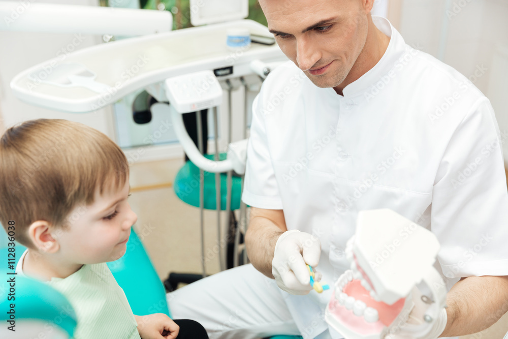 Dentist showing how to brush teeth and use toothbrush Dentist showing how to brush teeth and use toothbrush