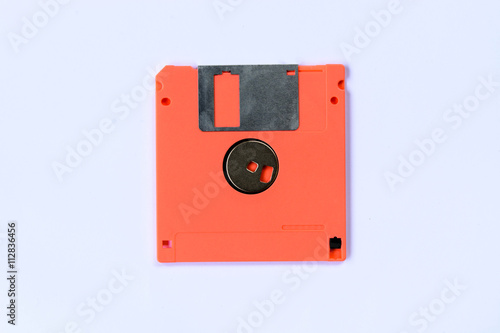 orange colorful floppy disk or diskette isolated on white backgr