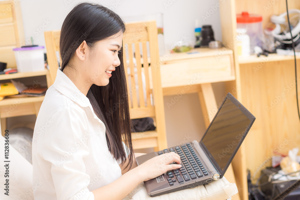 Portrait of happy asian woman using laptop Portrait of happy asian woman using laptop