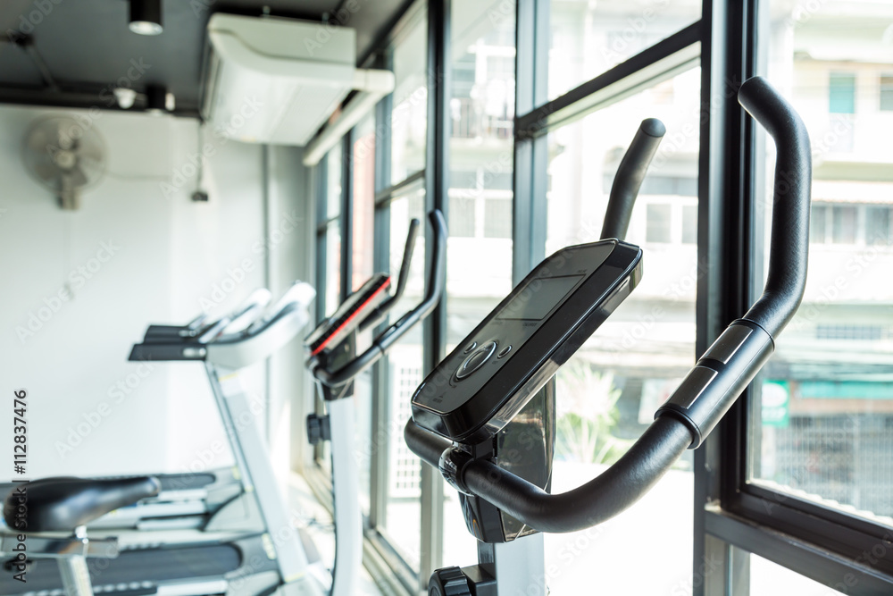 Exercise bikes in city gym fitness and health care concept