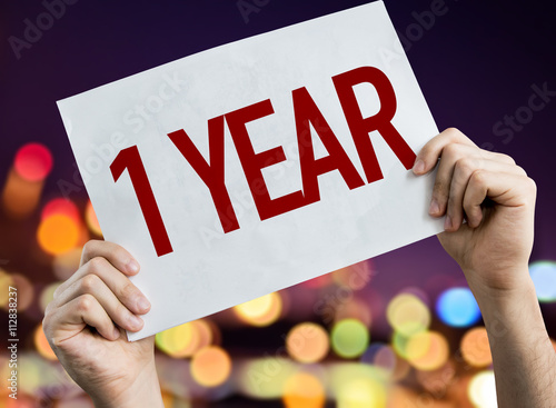 1 Year placard with night lights on background