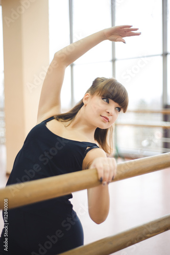 Dancer is doing exercises in ballet class