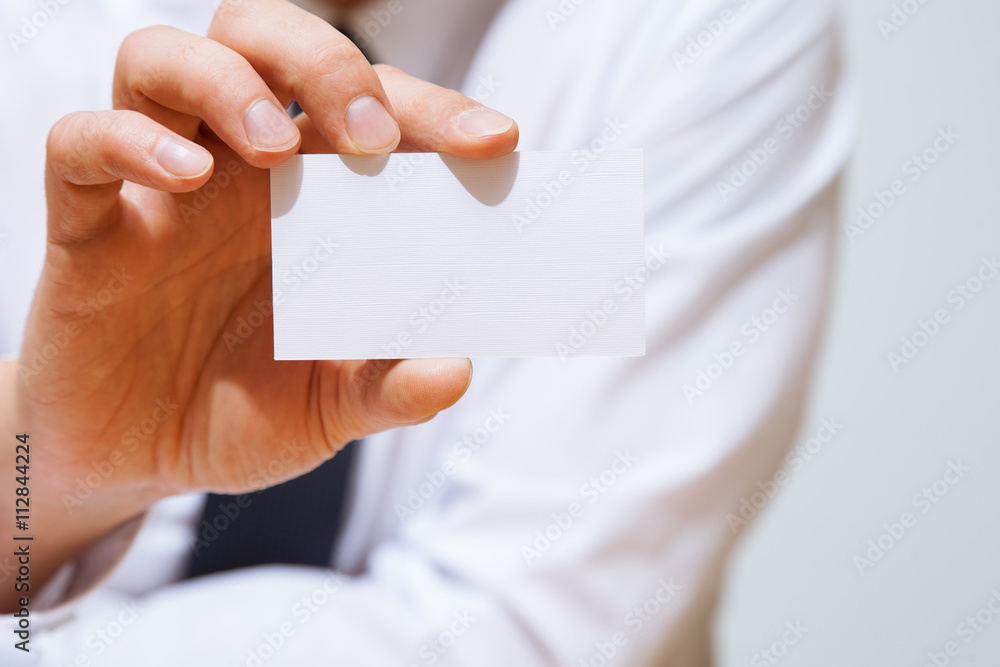 Businessman holding a business card Businessman holding a business card