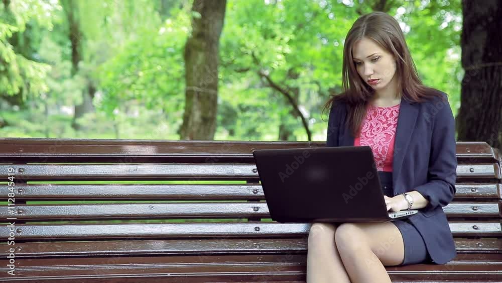 Young business woman with laptop working park bench Young business woman with laptop working park bench