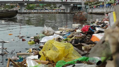 Plastic rubbish and paper waste in river water, water pollution, environmental and ecology issue