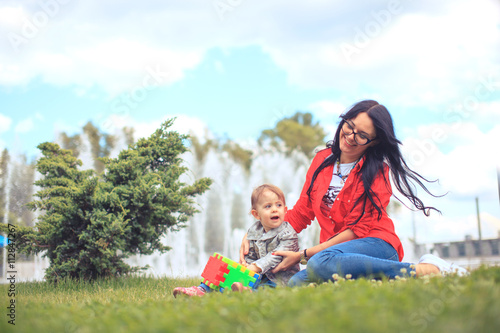 child play toy with mom in park happily