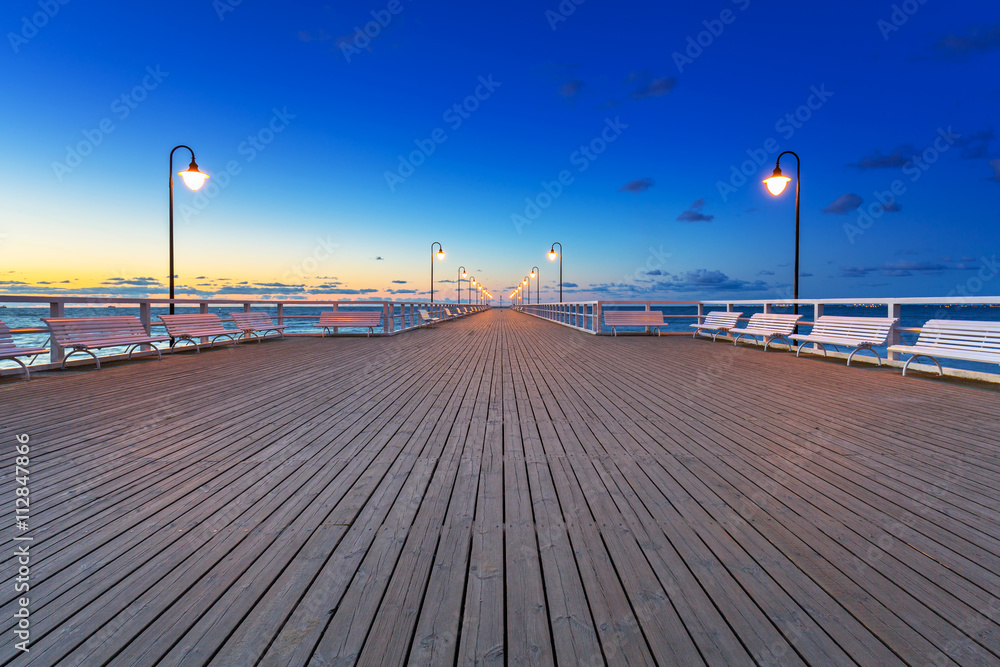 Wooden pier in Gdynia Orlowo at sunrise, Poland