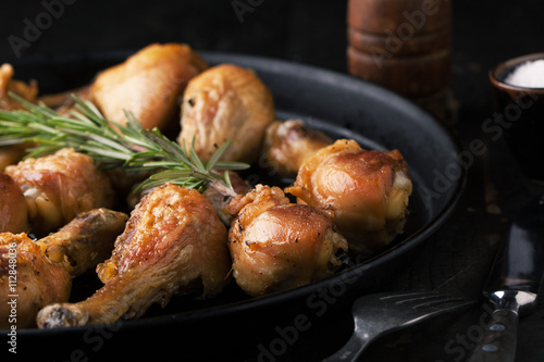 Fried chicken legs with spices and rosemary