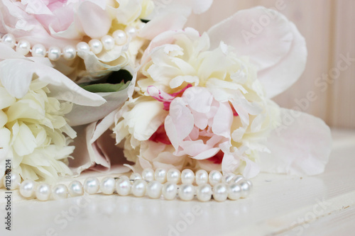 pale pink peonies with a necklace of white pearls