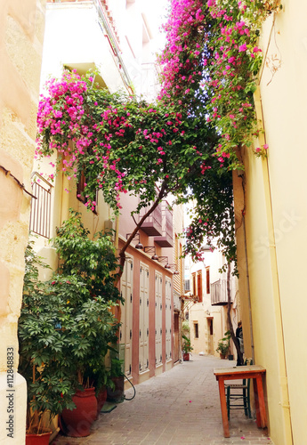 traditional street among bougainvillaea in chanya city Greece