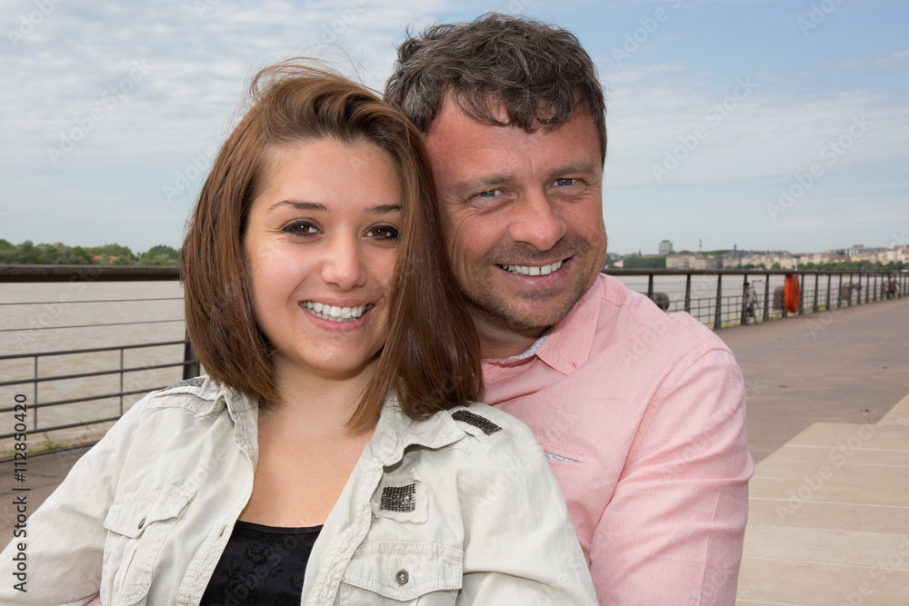 Portrait Of Smiling Couple near to the river on vacation tourism Portrait Of Smiling Couple near to the river on vacation tourism