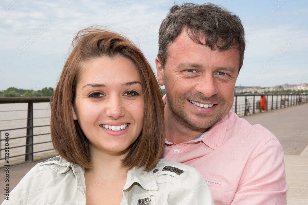 Portrait Of Smiling Couple near to the river on vacation tourism