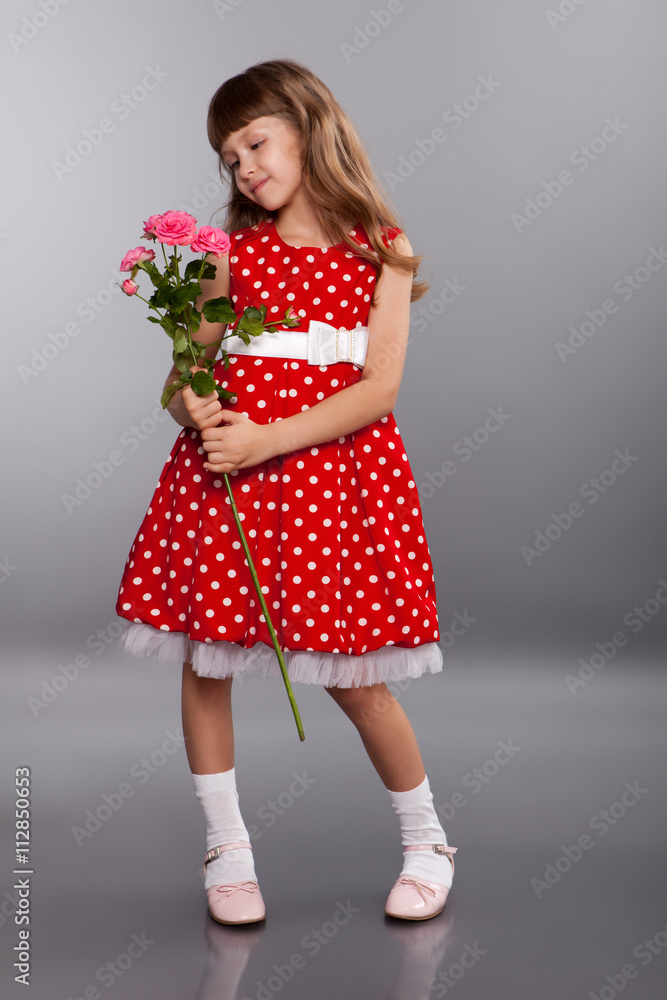 Smiling little girl holding flowers Smiling little girl holding flowers
