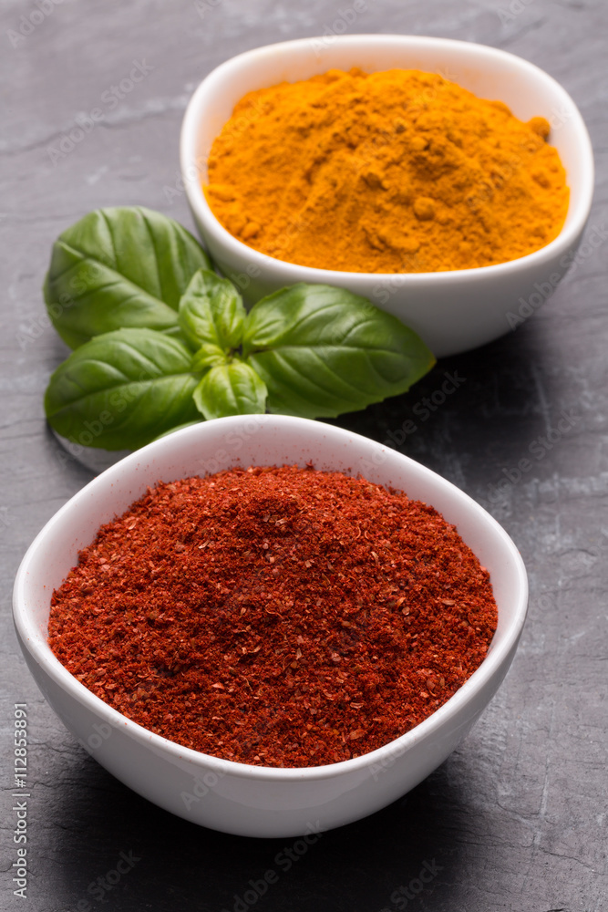 Tanduri Masala und Kurkuma mit Basilikum in weißer Schale auf d Tanduri Masala und Kurkuma mit Basilikum in weißer Schale auf d