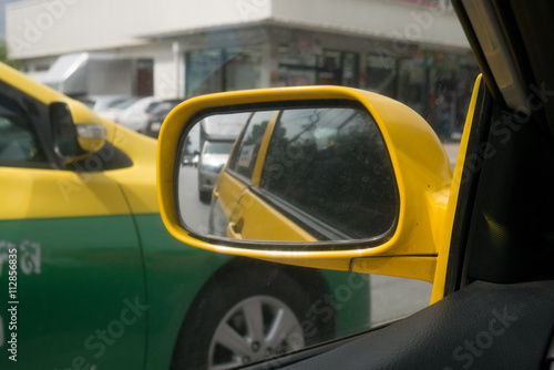 Reflection of a traffic jam in a side view mirror