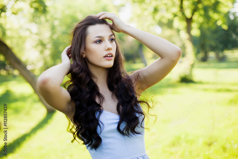 Portrait of a beautiful young Caucasian woman in a spring garden. Portrait of a beautiful young Caucasian woman in a spring garden.