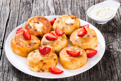 Delicious Cottage cheese pancakes with raisins and strawberries