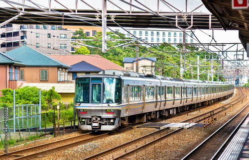 Rapid train is passing Maiko station, Japan