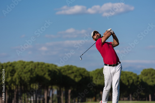 golf player hitting long shot