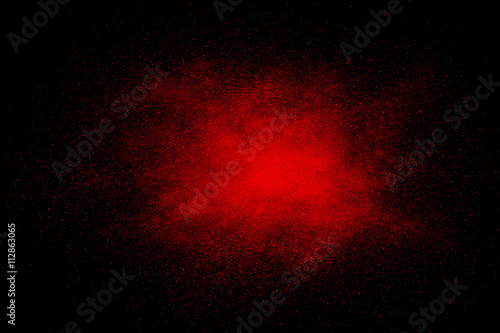 Red abstract powder explosion on a black background