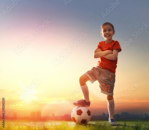 Child plays football.