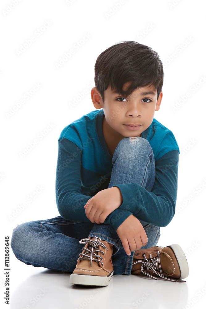 © mmilliman - Full length portrait of a young mixed race boy sitting on the floor. Isolated on white. © mmilliman - Full length portrait of a young mixed race boy sitting on the floor. Isolated on white.