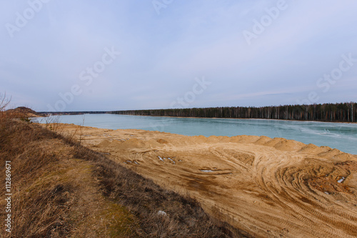 Fototapeta Naklejka Na Ścianę i Meble -  The quarry for extraction of sand and a frozen lake