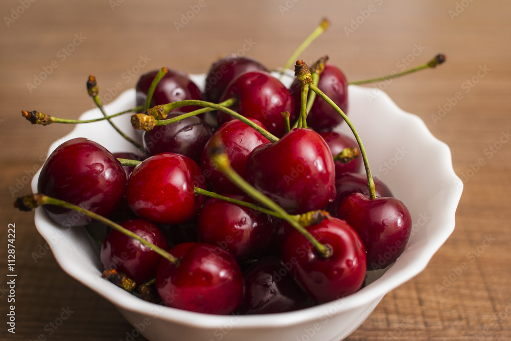 Cherries on wooden table with water drops macro background Cherries on wooden table with water drops macro background