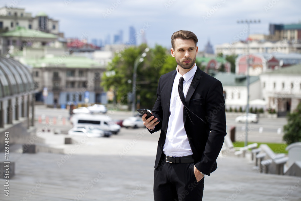 Young successful businessman calling by phone Young successful businessman calling by phone