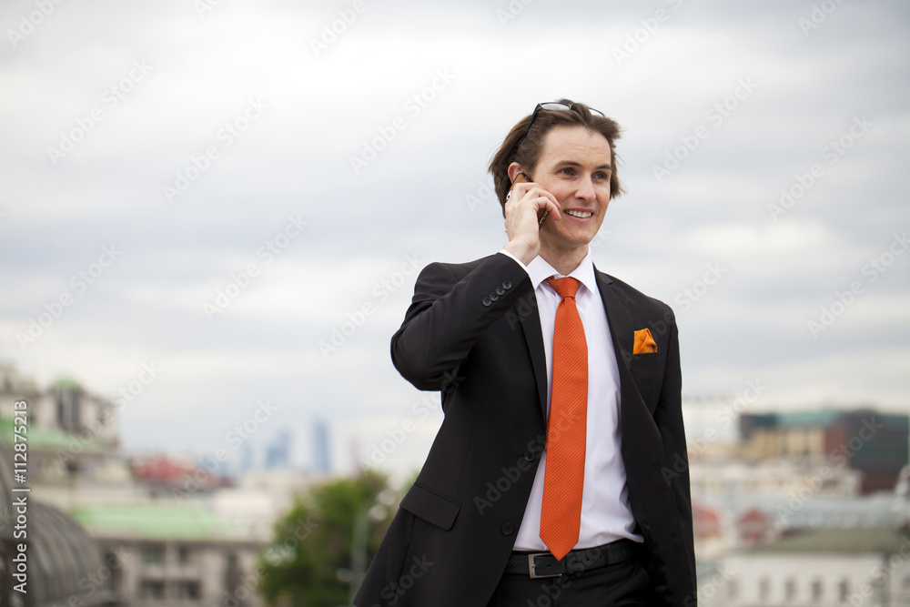 Young successful businessman calling by phone Young successful businessman calling by phone