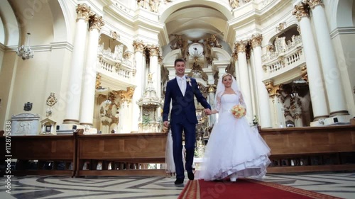 Bride and groom leaving the church after a wedding ceremony
