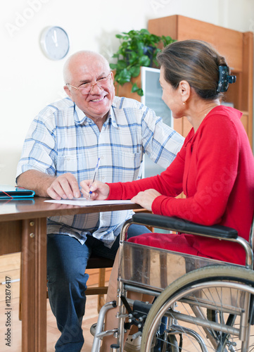  woman in wheelchair and elderly man