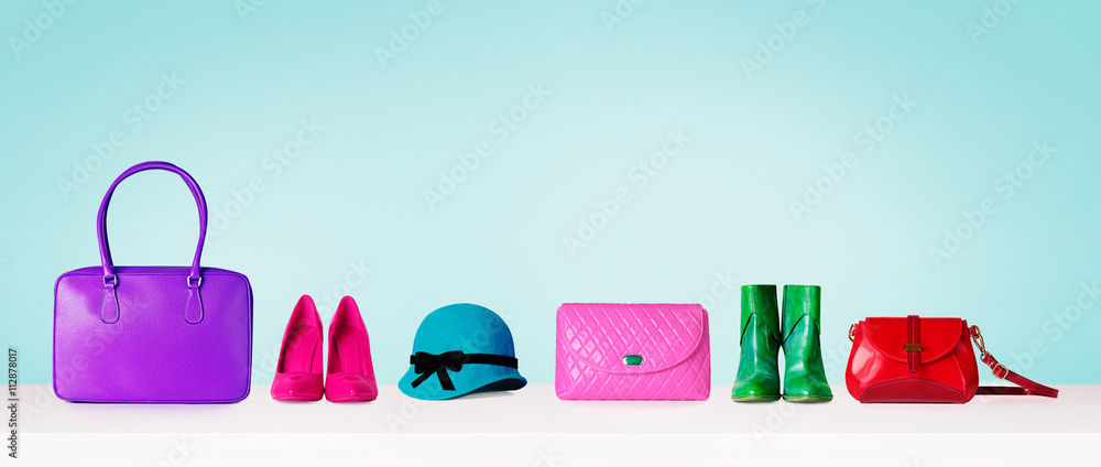 Woman accessories shopping items isolated on pastel color blue background. Shoes and purse bags and hat. with copy space.  - obrazy, fototapety, plakaty 