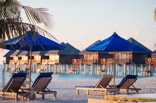 Sunbeds and umbrellas at beautiful tropical resort