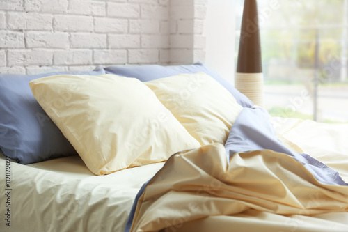 Unmade bed with crumpled bl...