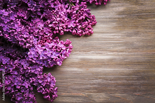 Fresh lilac on wooden background