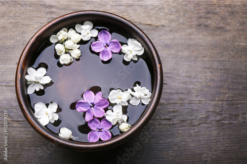 Fresh lilac flowers in the bowl  closeup