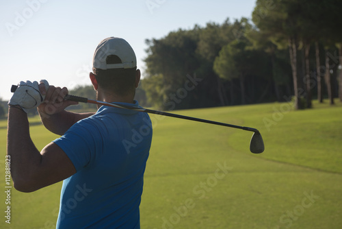 golf player hitting shot