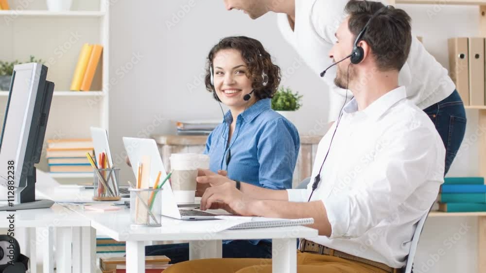 Pleasant colleagues sitting at the table Pleasant colleagues sitting at the table