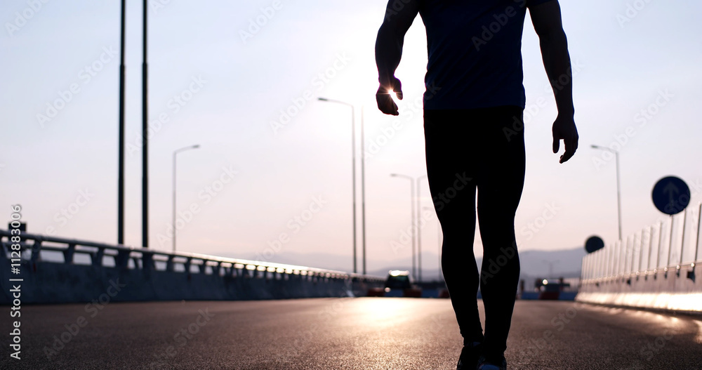 Running at sunrise man exercising for marathon and workout fitne