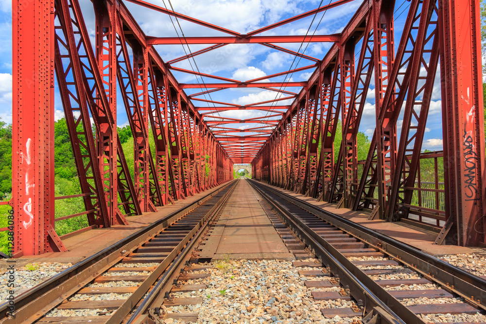 Railroad on a red bridge in summer day
