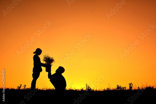 Silhouette children holding plant at sky sunset. Concept save world