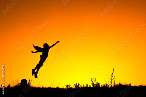 Silhouette a girl flying at sky sunset