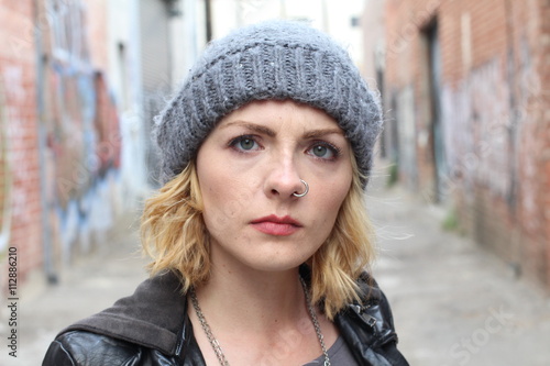 Portrait angry blonde woman on urban cool background