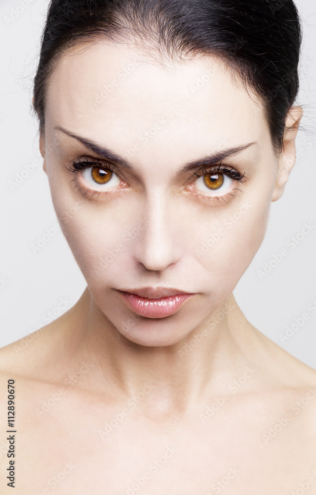 Portrait of beautiful young woman looking at camera. Portrait of beautiful young woman looking at camera.
